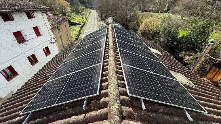 Placas solares en las dos vertientes de un tejado en un valle de Ataun, País Vasco