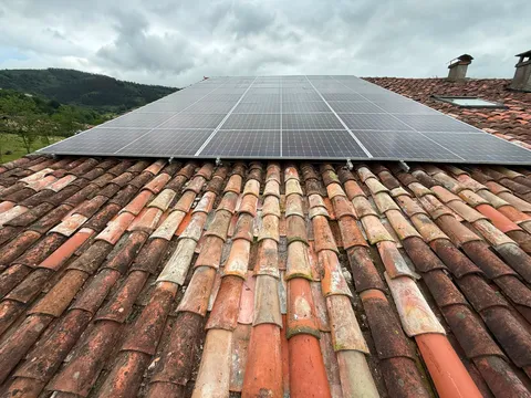 Paneles solares sobre tejado de teja con vistas al valle en Elorrio